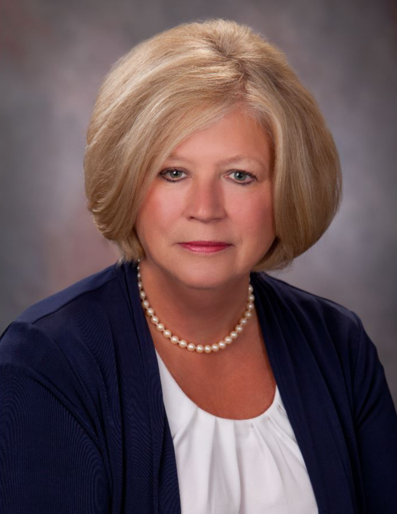 Diane Sauer standing at Diane Sauer Chevrolet dealership in Warren OH